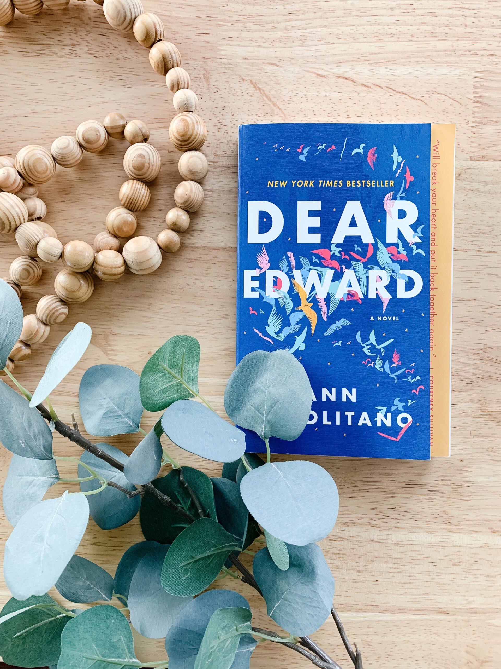 Dear Edward book on a table with eucalyptus. 