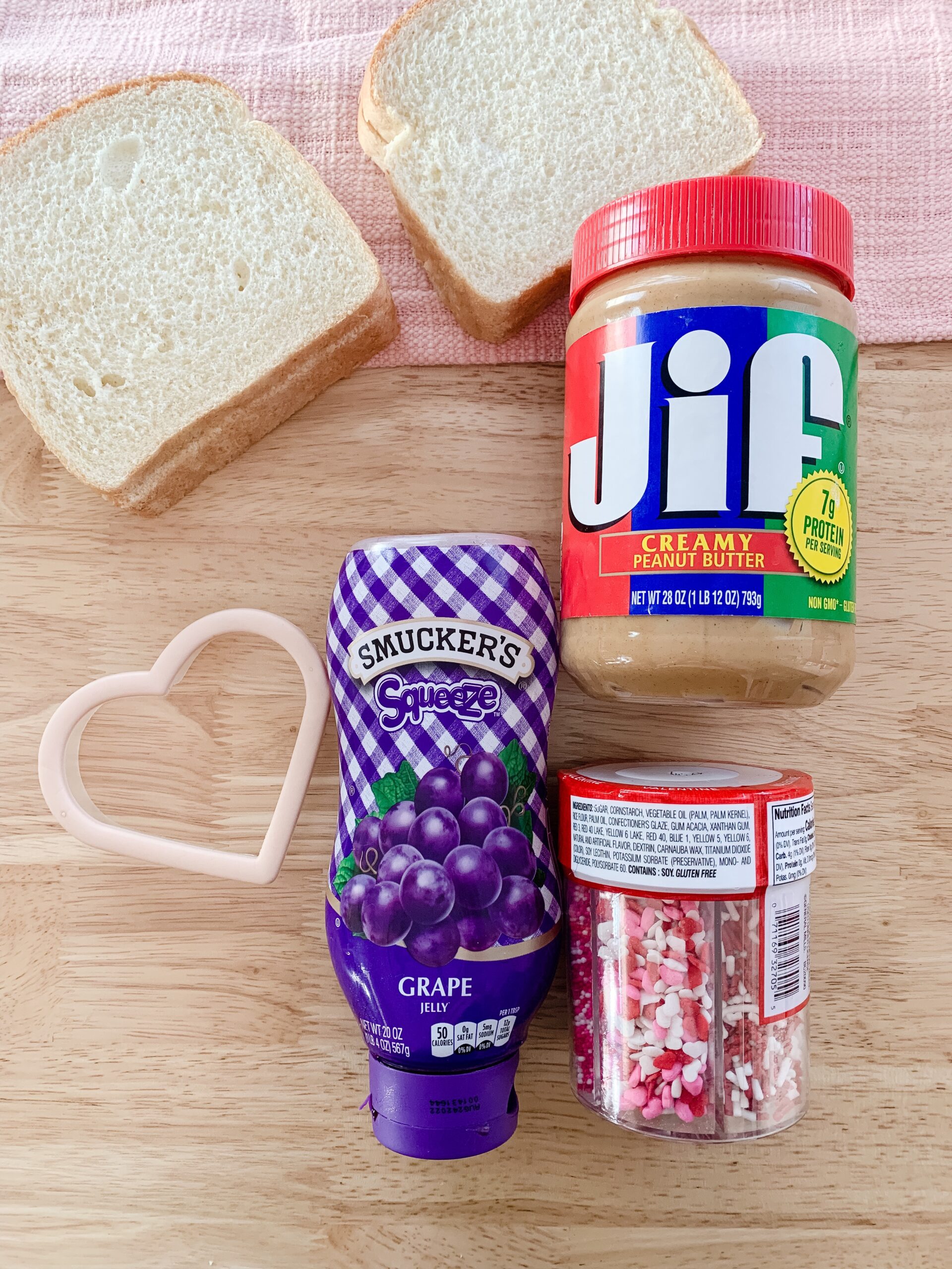 White bread, Jif peanut butter, smucker's grape jelly, Valentine's sprinkles and a heart shaped cookie cutter