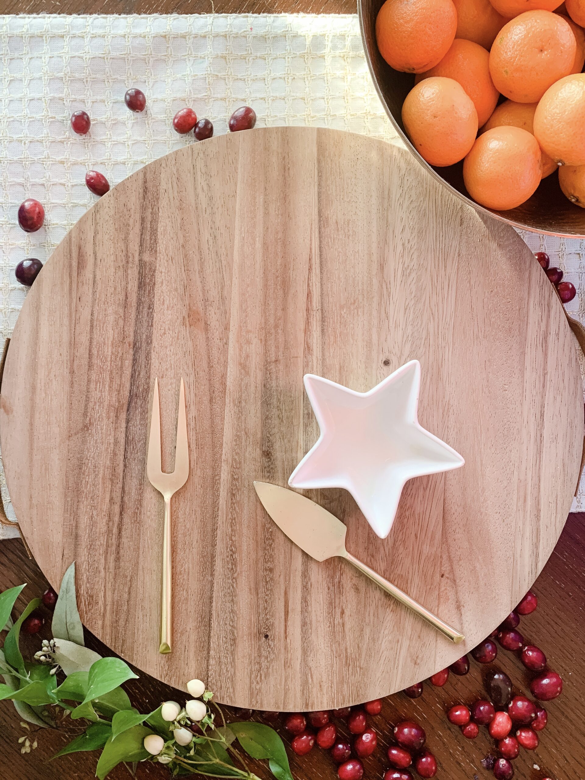 round cheese board with gold cheese knives 