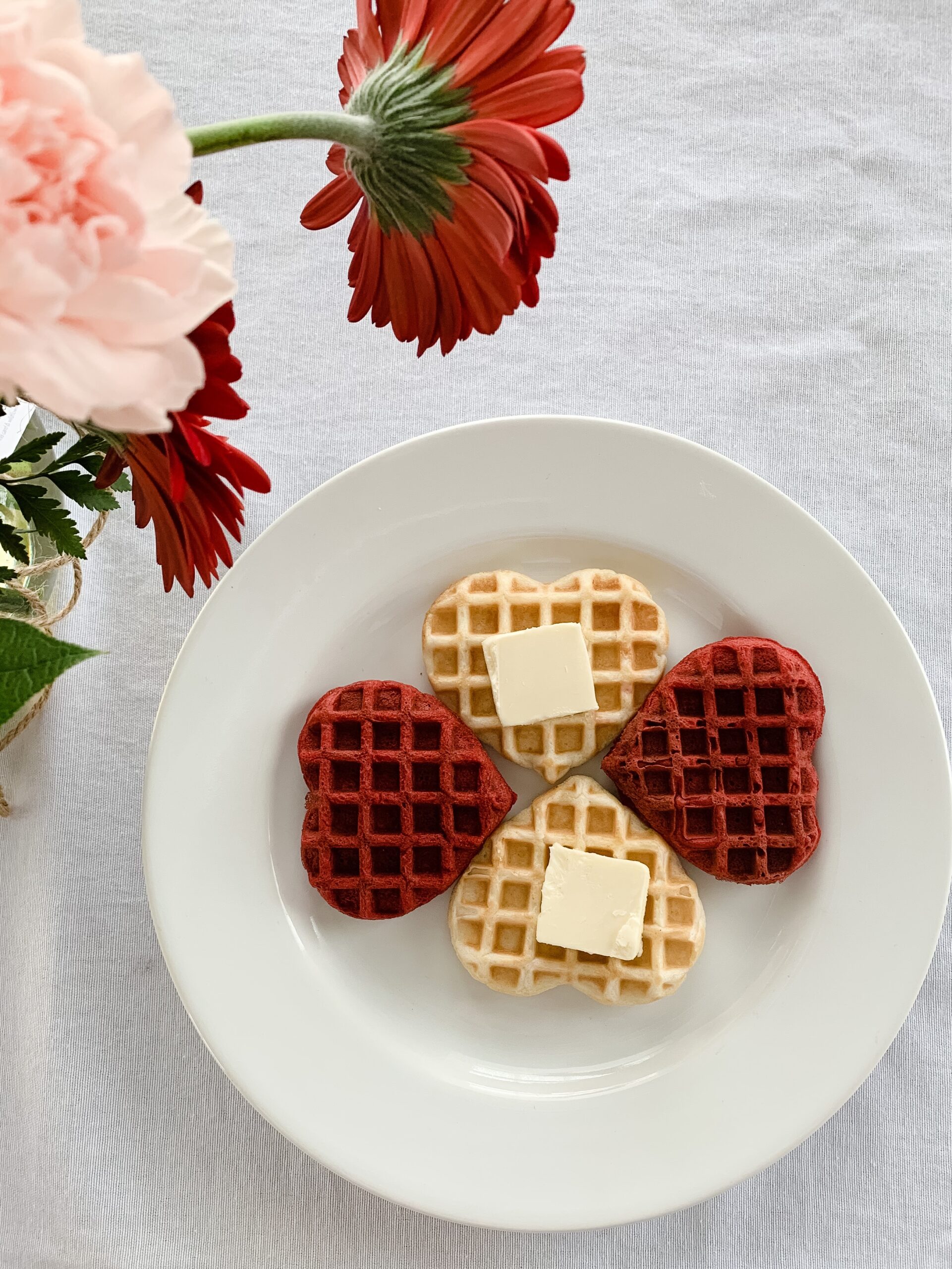 four heart shaped waffles on a plate