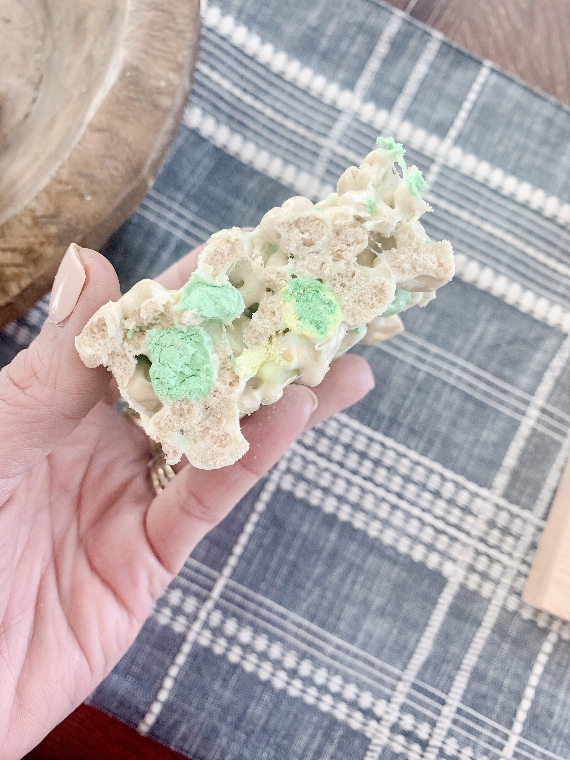 woman's hand holding a Lucky Charms Treat