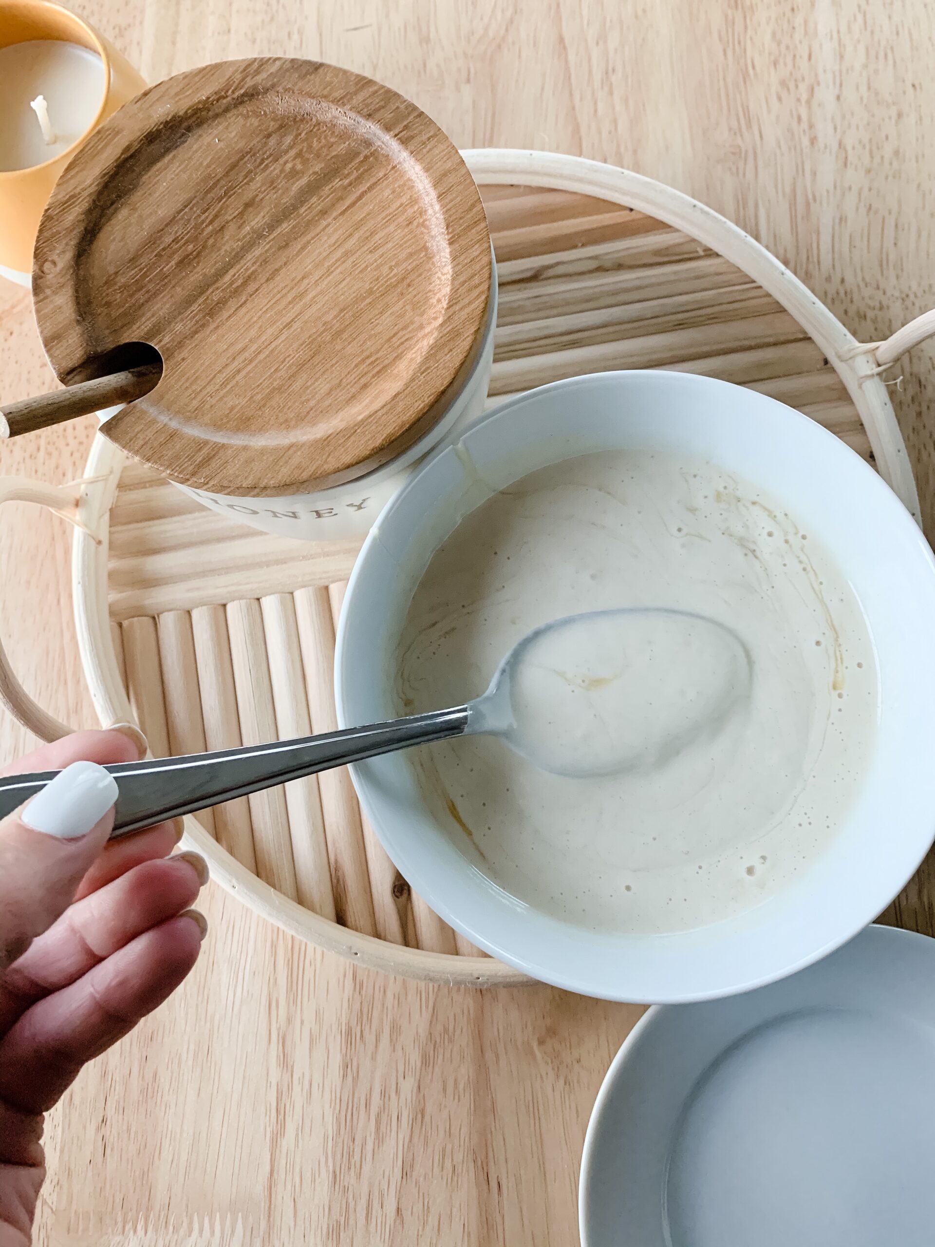 spoon mixing honey into waffle batter