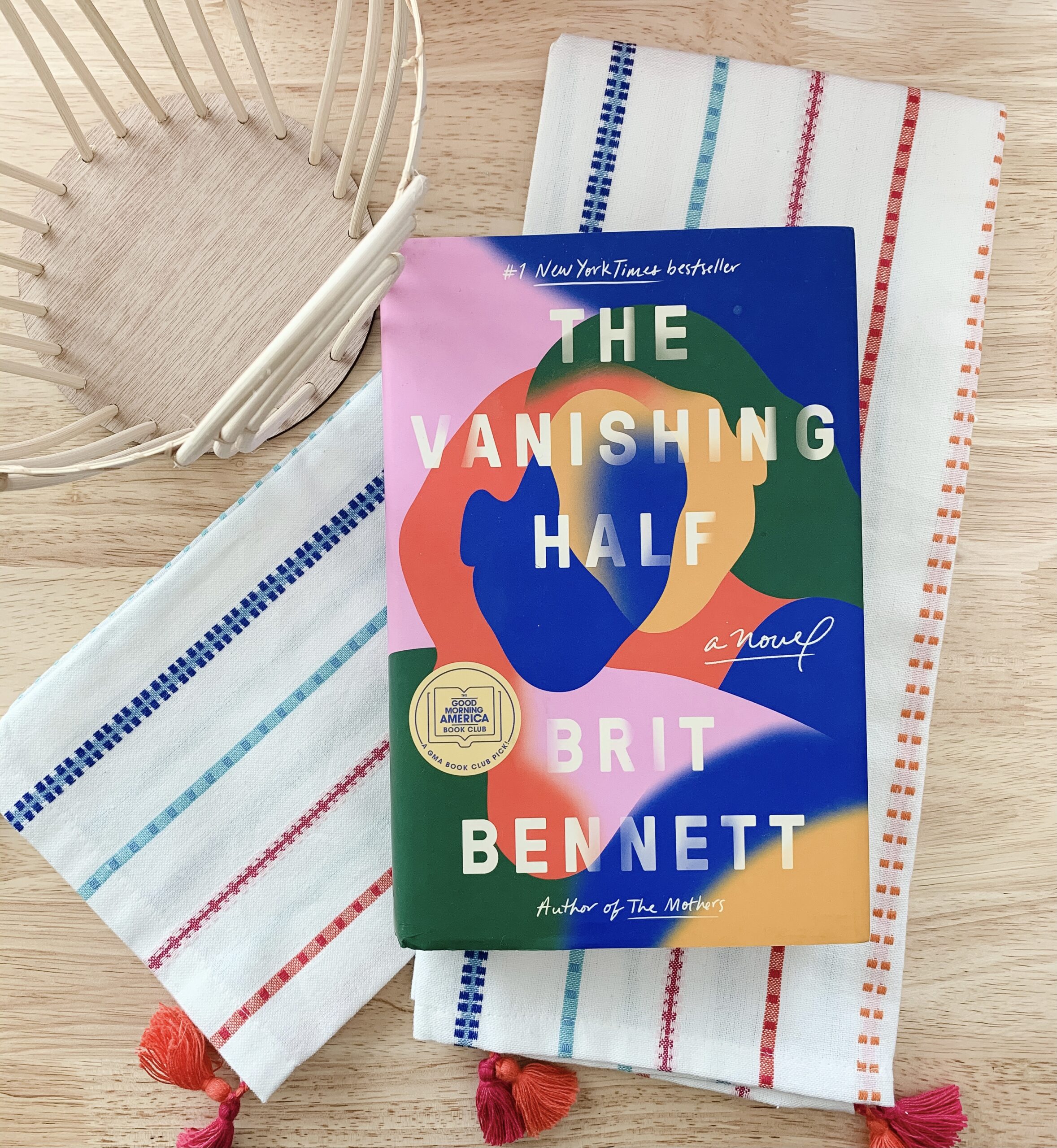 image of bright colored towels and cover of the novel The Vanishing Half by Brit Bennett